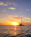 Sunset behind cruising sailboat in the Bahamas